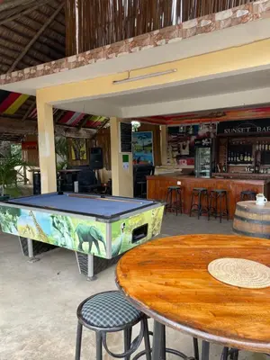 a ping pong table and two tables in a restaurant at Viva Tanzania in Arusha