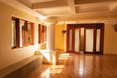 an empty room with a column and windows at Viva Tanzania in Arusha