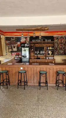 a sunburst bar with four stools in front of it at Viva Tanzania in Arusha