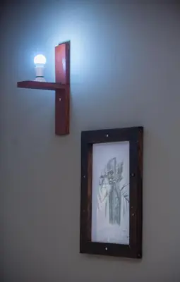a picture of a man on a wall with a blue light at Arusha Giraffe Lodge in Arusha