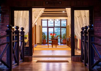 an open door to a dining room with a table at The Retreat at Ngorongoro in Karatu