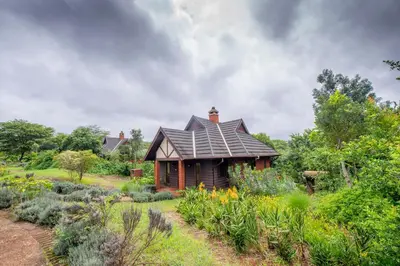 a small house in the middle of a garden at The Retreat at Ngorongoro in Karatu