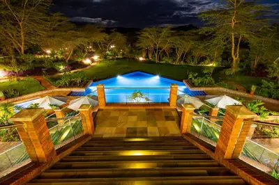 a staircase leading up to a house at night at The Retreat at Ngorongoro in Karatu