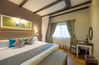 a bedroom with a large bed and a window at The Retreat at Ngorongoro in Karatu