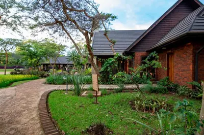 a house with a garden in front of it at The Retreat at Ngorongoro in Karatu