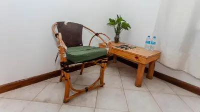 a chair and a table with a bottle of water at City Villa in Arusha