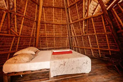 a room with a bed in a straw hut at City Villa in Arusha
