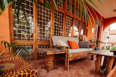 a porch with a bench and a window at City Villa in Arusha