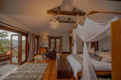 a bedroom with a bed with a canopy at Escarpment Luxury Lodge Manyara in Mto wa Mbu