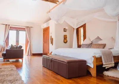 a bedroom with a large bed with a canopy at Escarpment Luxury Lodge Manyara in Mto wa Mbu