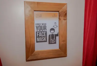 a picture frame hanging on a wall with a poster at Escarpment Luxury Lodge Manyara in Mto wa Mbu