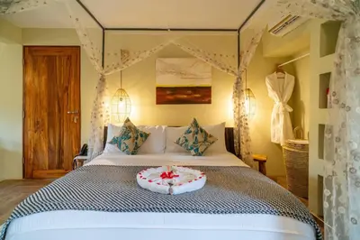 a bedroom with a bed with a cake on it at Escarpment Luxury Lodge Manyara in Mto wa Mbu