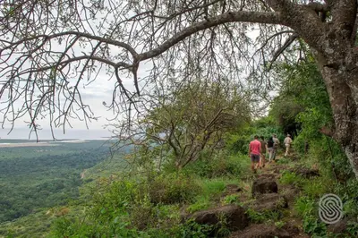 a group of people walking on a mountain trail at Lake Manyara Serena Safari Lodge in Karatu