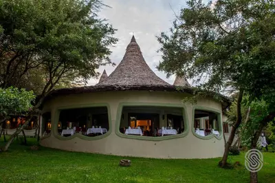 a house with a large window with a roof at Lake Manyara Serena Safari Lodge in Karatu