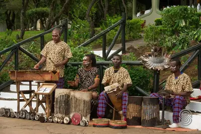 a group of men in cheetah patterned shirts sitting at Lake Manyara Serena Safari Lodge in Karatu