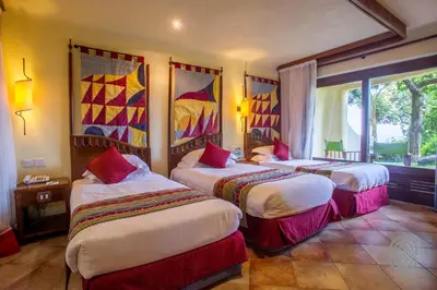 a hotel room with two beds and a window at Lake Manyara Serena Safari Lodge in Karatu