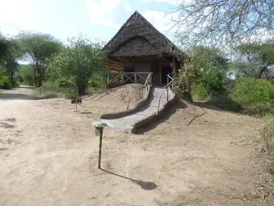 a log cabin with a staircase in front of it at Roika Tarangire Tented Lodge in Kwa Kuchinia