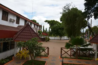 a courtyard of a building with a yellow table at Keys Hotel in Moshi