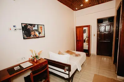 a bedroom with a desk and a bed and a desk sidx sidx sidx at Keys Hotel in Moshi