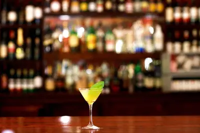 a drink in a martini glass sitting on a bar at Keys Hotel in Moshi