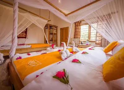 two stuffed animals sitting on a bed in a room at Meru View Lodge in Usa River