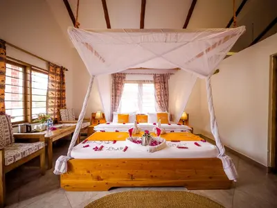 a bedroom with a bed with a canopy at Meru View Lodge in Usa River