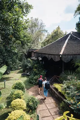 two people walking in front of a building at Aishi Machame in Moshi