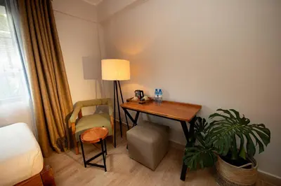 a room with a desk and a chair and a lamp at Aishi Machame in Moshi