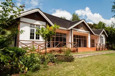 a house with a porch and a yard at Aishi Machame in Moshi