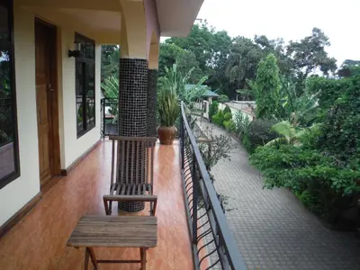a balcony with a bench on a house at Bright Star Hotel & Safaris in Arusha