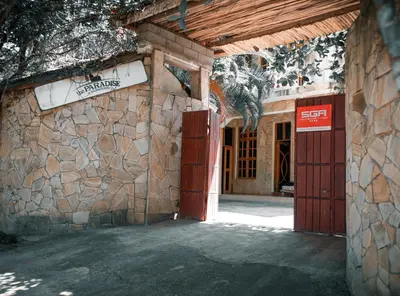 an entrance to a building with a stone wall at The Paradise Inn Kilimanjaro in Moshi