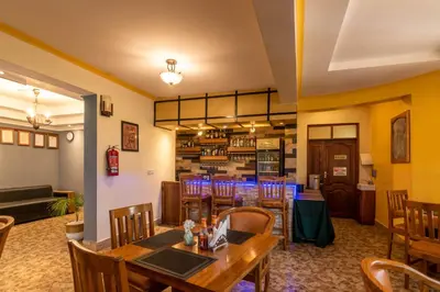 a dining room with a table and chairs at Crest Safari Lodge Bed and Breakfast in Arusha