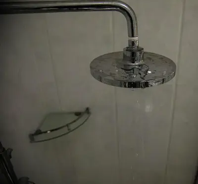 a shower head with water coming out of it at Panama Garden Resort in Moshi