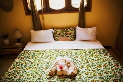 a bedroom with a bed with a teddy bear on it at More Than A Drop in Moshi
