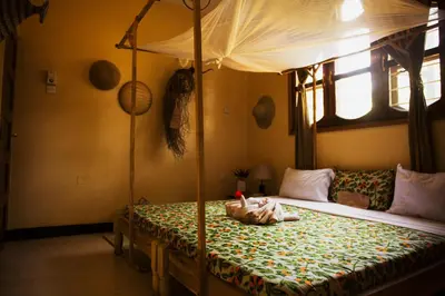 a bedroom with a bed with a canopy at More Than A Drop in Moshi
