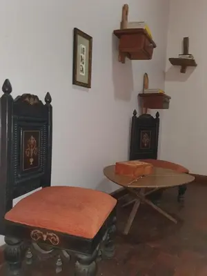 a room with two tables and a table and chairs at Boulevard Inn Mt Meru in Arusha