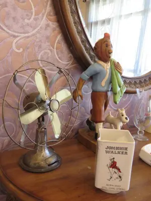 a statue of a teddy bear and a fan on a table at Boulevard Inn Mt Meru in Arusha