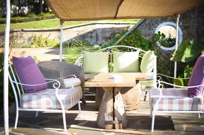 a group of chairs and a table and a table and chairs at Boulevard Inn Mt Meru in Arusha