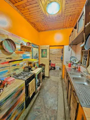 a kitchen with a stove and a sink at Mazzola Safari House & Backpacking in Arusha