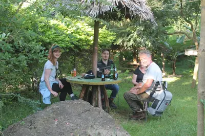 a group of people sitting around a picnic table at Endasawa Tree Lodge in Usa River