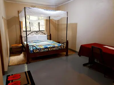 a bedroom with a bed with a canopy at Endasawa Tree Lodge in Usa River