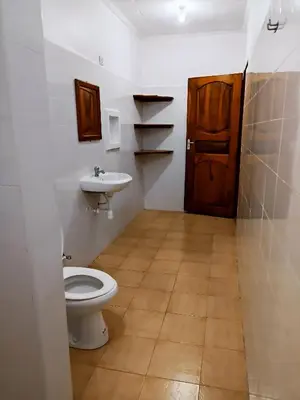 a bathroom with a toilet and a sink at Endasawa Tree Lodge in Usa River