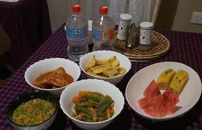 a table with four bowls of food and water bottles at Endasawa Tree Lodge in Usa River