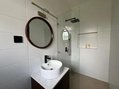 a white bathroom with a sink and a mirror at Bristol Cottages Kilimanjaro in Moshi