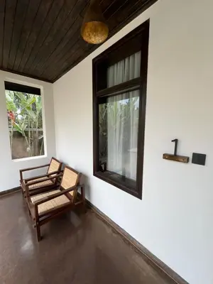 a room with a chair and a window at Bristol Cottages Kilimanjaro in Moshi