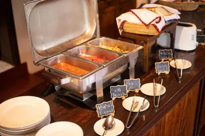a buffet with some food on a table at Bristol Cottages Kilimanjaro in Moshi