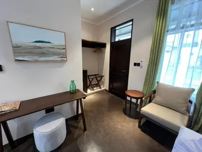 a room with a desk and a chair and a window at Bristol Cottages Kilimanjaro in Moshi