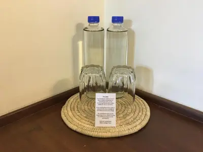 two empty wine glasses sitting on top of a table at Bristol Cottages Kilimanjaro in Moshi