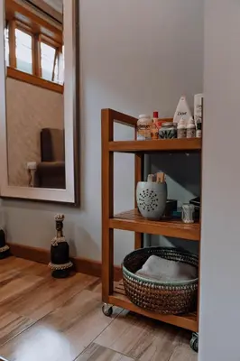 a room with a shelf with dishes and a mirror at Airport Planet Lodge in Kingori