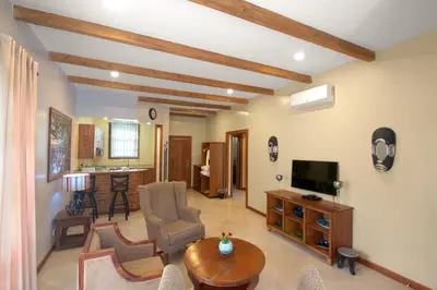 a living room with a television and a table at Airport Planet Lodge in Kingori